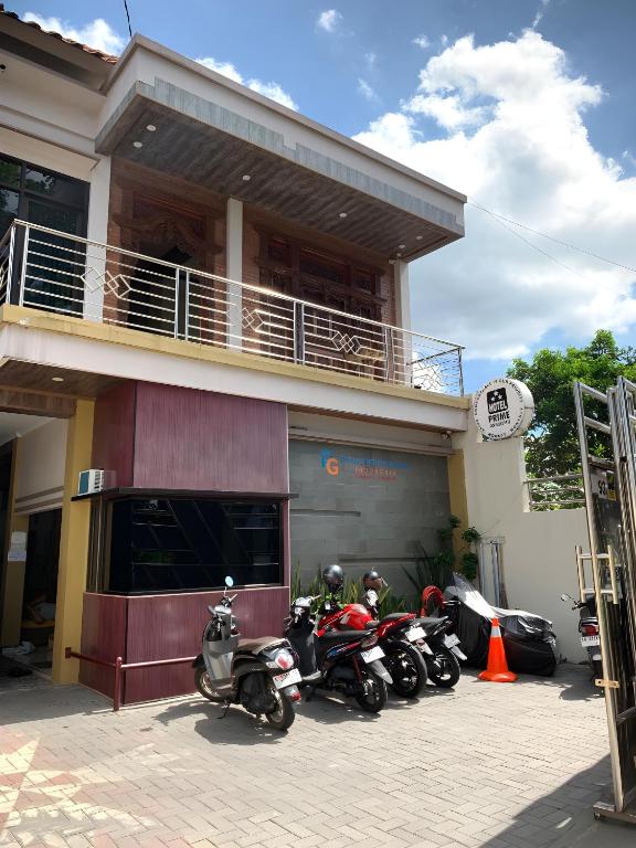 a group of motorcycles parked outside of a building at Prime Adisucipto Hotel in Kalasan