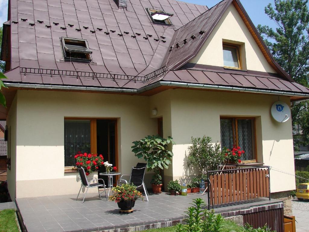 a house with a purple roof and a patio at Kalina in Zakopane