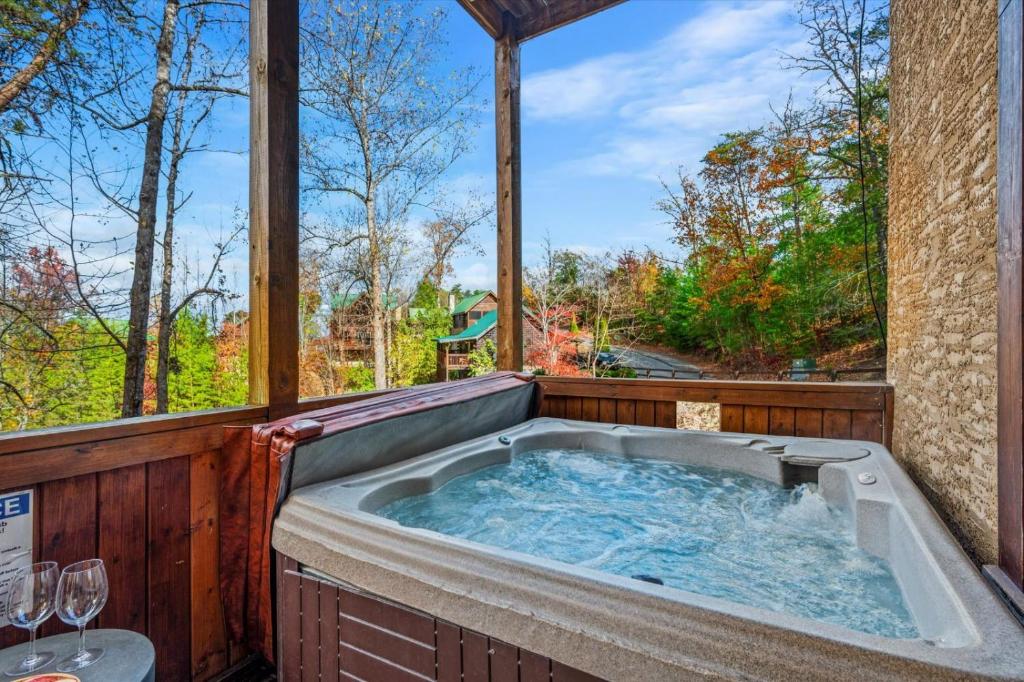 a jacuzzi tub with a view of the woods at Blue Ridge Retreat in Pigeon Forge