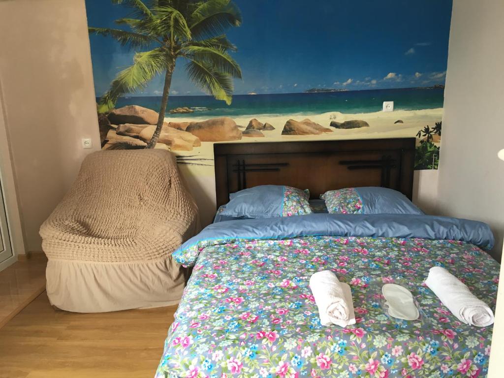 a bedroom with a bed with a painting of a beach at Hotel Prime in Mtskheta