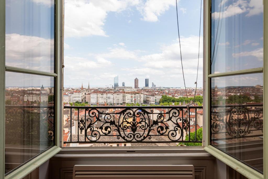 a balcony with a view of a city at Smartstay - Vue panoramique sur Lyon et la saone in Fourvière