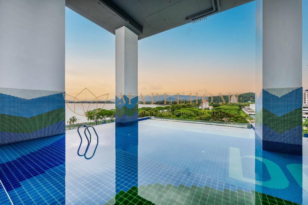 a swimming pool on the roof of a building with a view at Bay Suites Premier Suites Kota Kinabalu in Kota Kinabalu