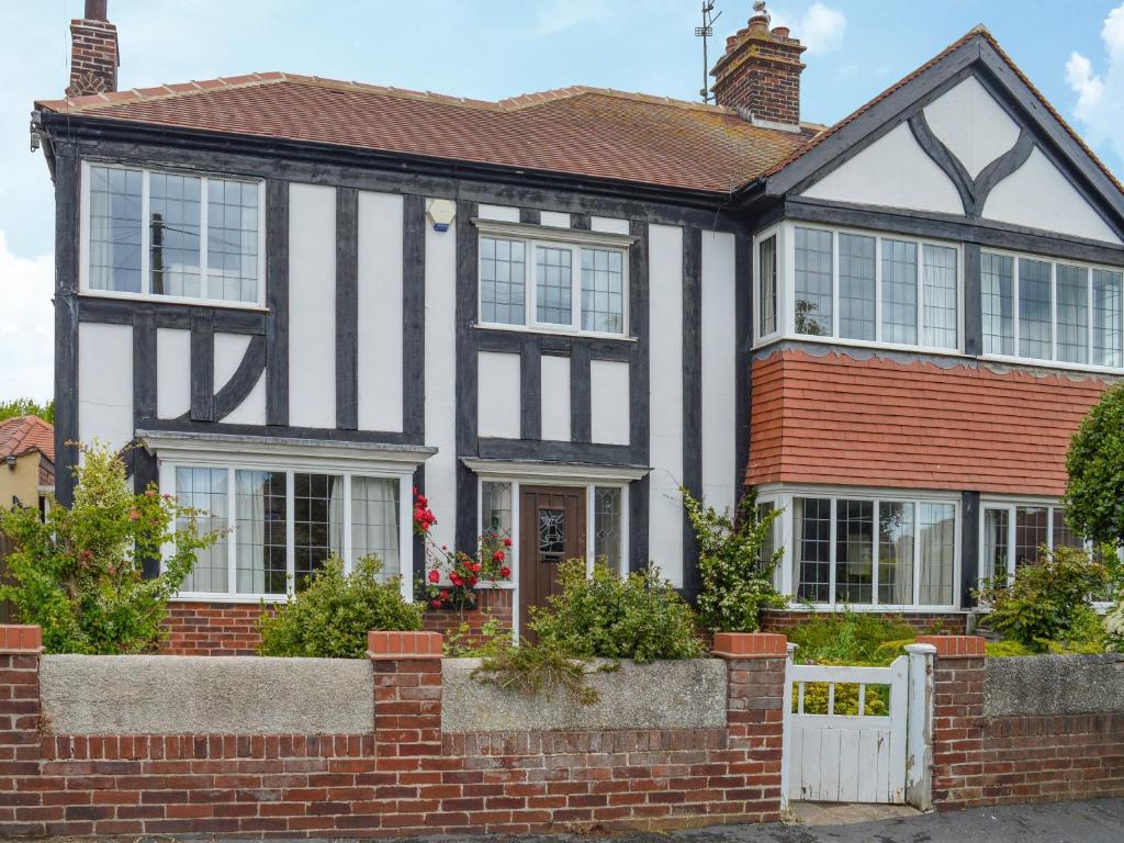 a black and white house with a brick fence at Number Three in Bridlington