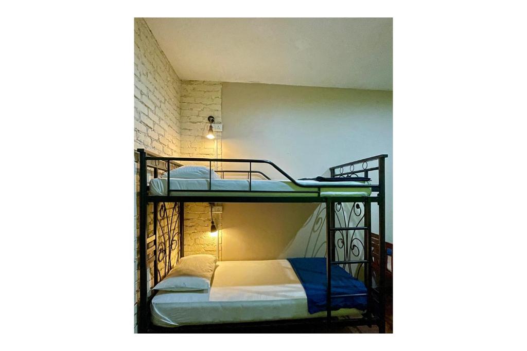 a bunk bed room with two bunk beds in it at The Explorers Guesthouse and Hostel in Kuala Lumpur