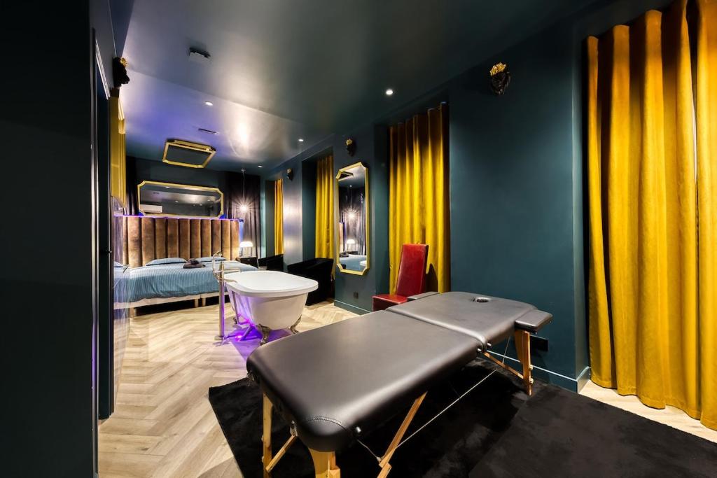 a bathroom with a bathtub and a bed in a room at La Suite Versailles freeParking table massage Clim in Montreuil