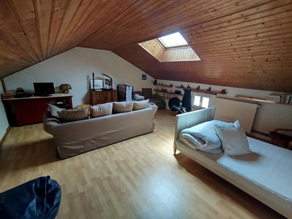 a living room with two couches and a skylight at La loutre - 8 personnes in Mortagne-sur-Sèvre