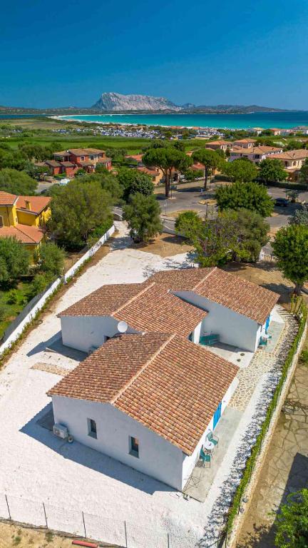 an aerial view of a white building with red tile roofs at Luxury Home La Cinta in San Teodoro