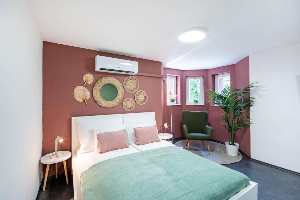 a bedroom with a bed and two chairs at Central - Green - Stylish - Quiet Sleep in Debrecen