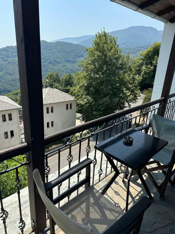 a table and chairs on a balcony with a view at Φιλυρέα Apartments - Room 2 in Zagora