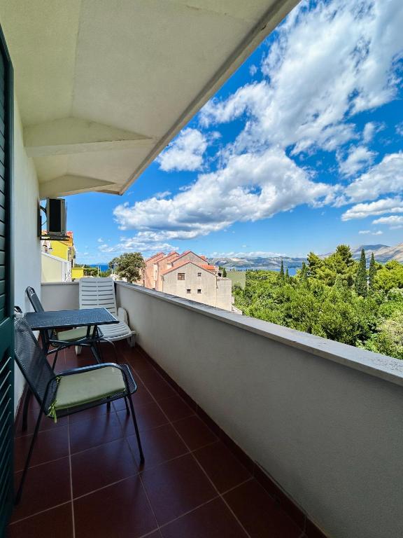 a balcony with a table and chairs and a view at Guest House Sol in Cavtat