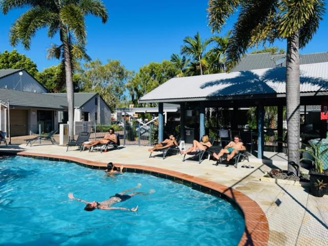 a group of people sitting in chairs in a swimming pool at Nautilus Noosa Resort in Noosaville