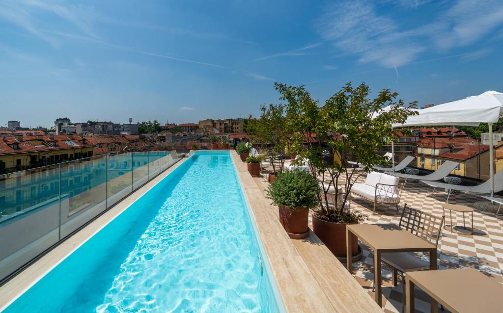 a swimming pool on the roof of a building at Hotel Calimala Milano in Milan