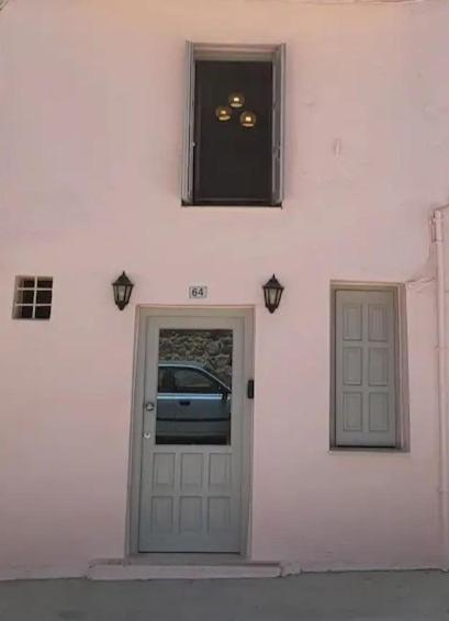 a white building with a door and a window at Fortezzino in Rethymno