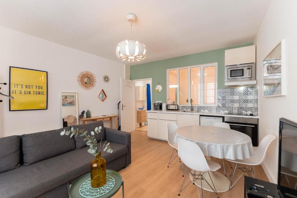 a living room with a couch and a table at Colmar City Center - Modern Studio COCOON - BookingAlsace in Colmar