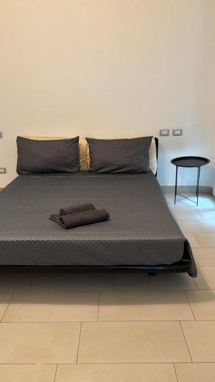 a bed with two brown pillows on top of it at Urban Apartments Vigevano - Appartamento Ciocca 1 in Vigevano