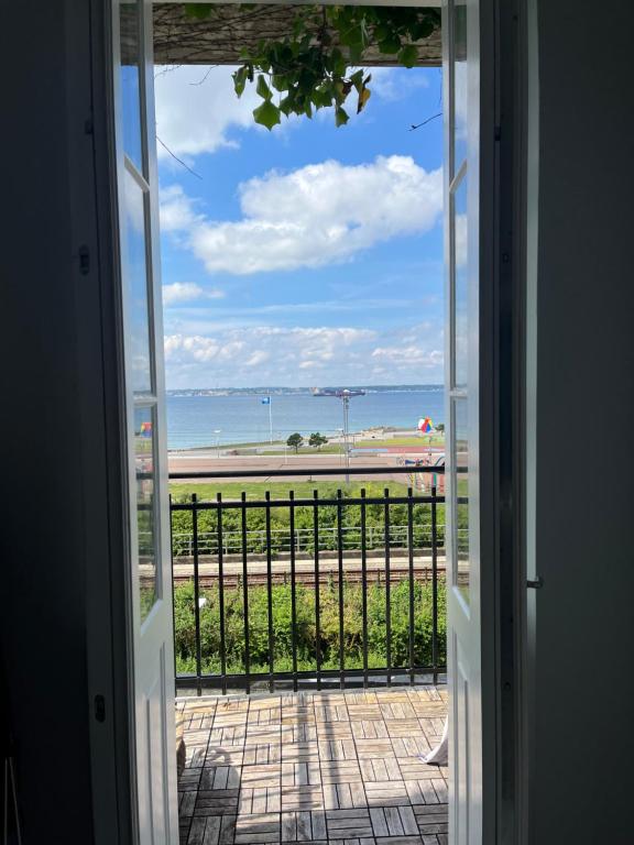 an open door to a view of the beach at Fria Bad in Helsingborg