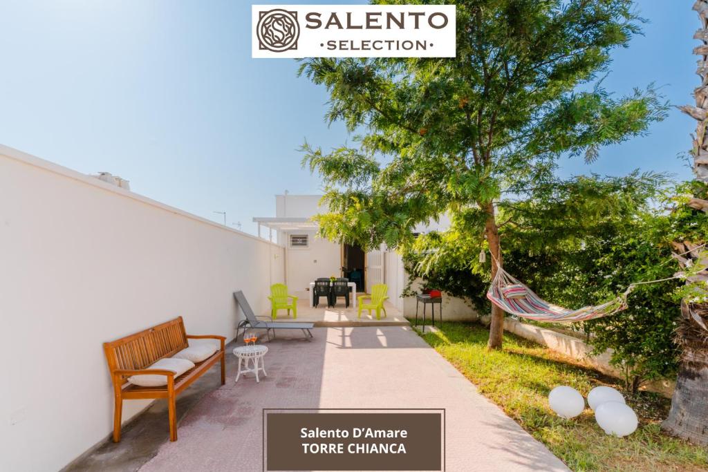 a patio with a hammock and a tree at Salento D'Amare - Salento Selection in Torre Chianca