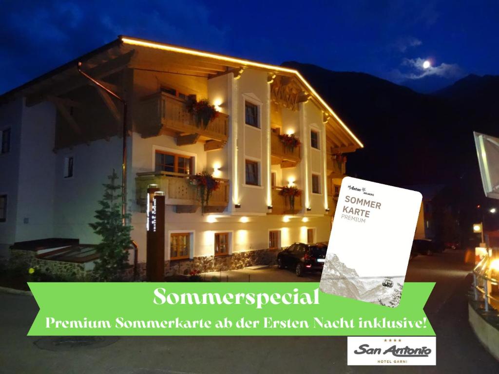 a building with a sign in front of it at night at Apart Hotel San Antonio, Premium Sommerkarte inkludiert in Sankt Anton am Arlberg