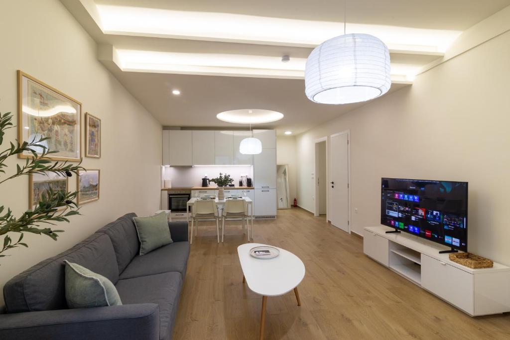 a living room with a couch and a tv at Elea in Mytilene