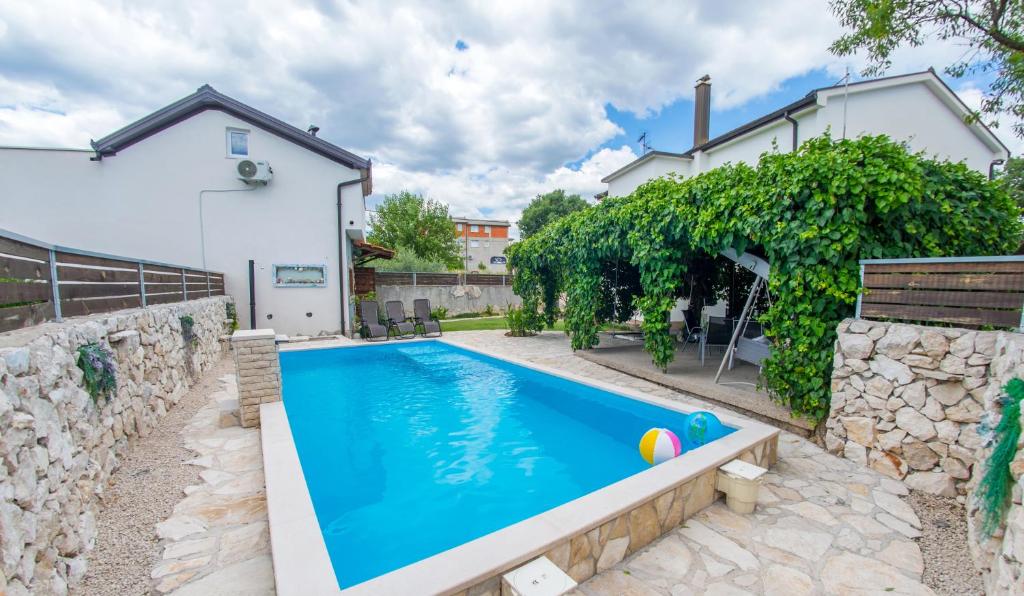 a swimming pool in the backyard of a house at Estate - Villa Discovery in Ljubuški