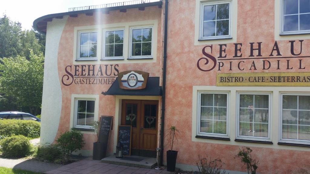 a building with a sign on the front of it at Hotel am Untreusee in Hof