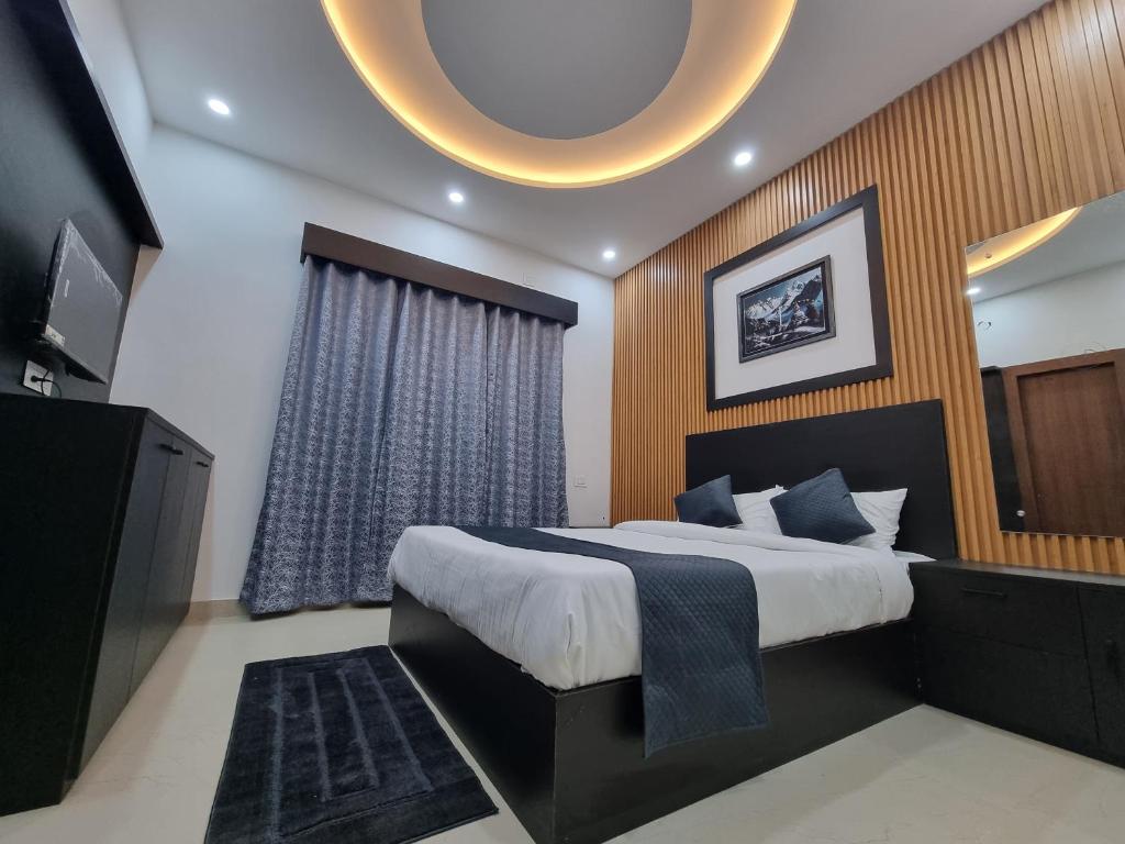 a bedroom with a large bed and a television at The Regal Vistas Hotel and Banquet in Siliguri
