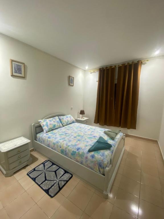 a small bedroom with a bed and a window at Appartement Najma in Tangier