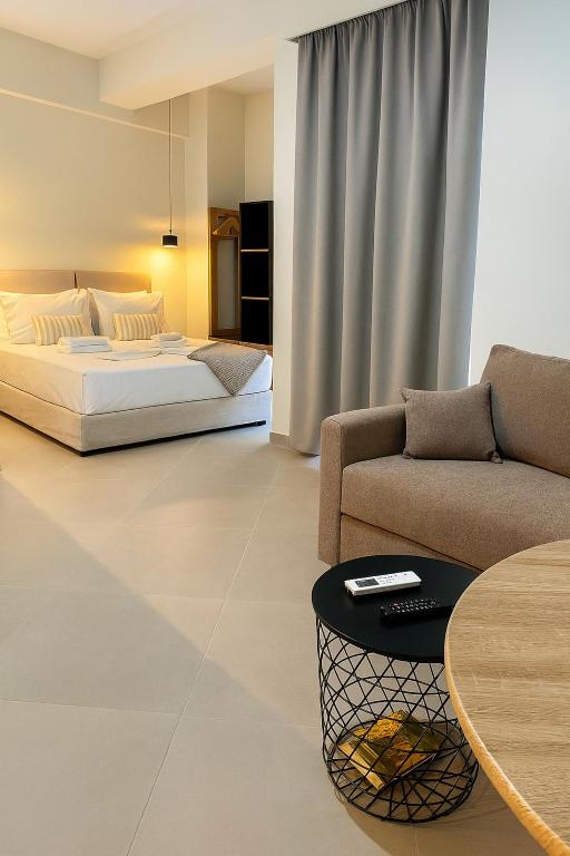 a bedroom with a bed and a couch and a table at ATHENIAN Vibes in Athens