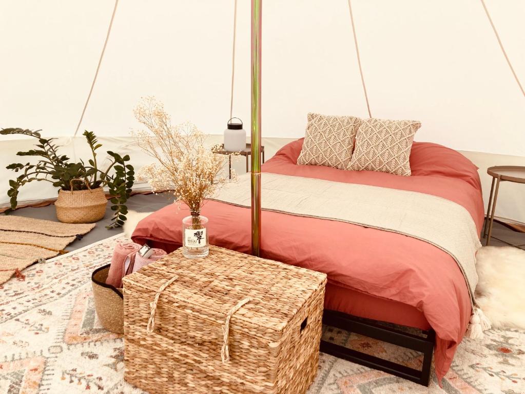 a bedroom with a bed with a wooden trunk at The Rounds in Pembrokeshire