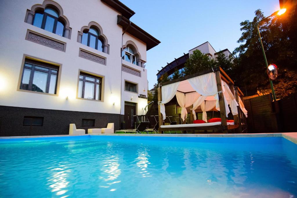 a swimming pool in front of a building at Cetate Residence in Braşov