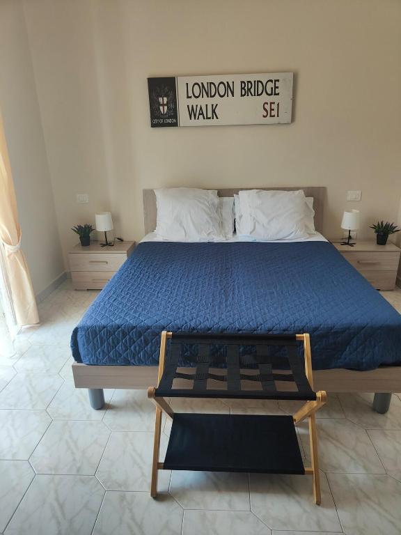 a bedroom with a large bed with a blue comforter at Hyria Intero Appartamento in centro città in Avellino