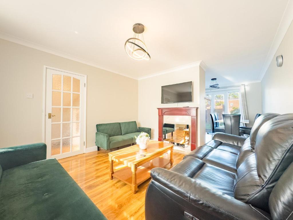 a living room with a couch and a table at House - sleeps 7 private garden & parking in Basildon