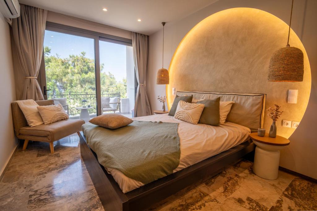 a bedroom with a bed and a large window at East Blue Luxury Apartment in Kamári