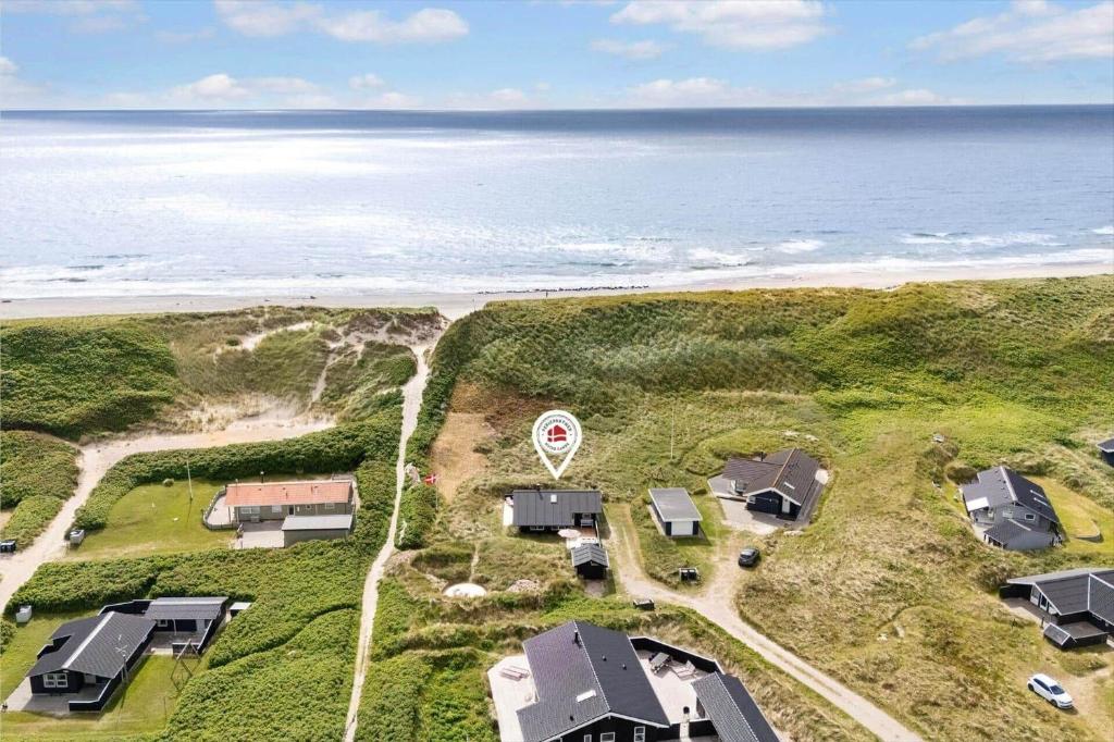 an aerial view of a house near the ocean at 440-Hvide-Sande-Strandkrogvejen-60 in Hvide Sande