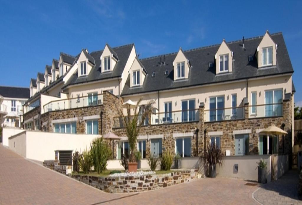 a large apartment building with a large roof at The Treyarnon Suite in St Merryn