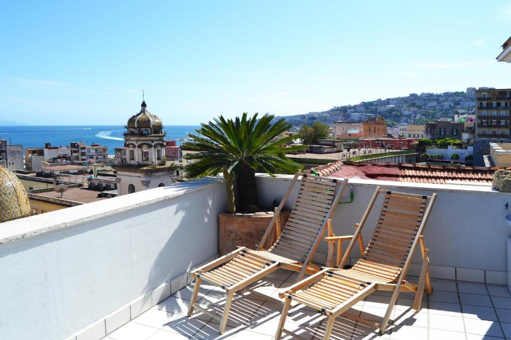 two chairs on a balcony with a view of the city at Apartment Martucci with Seaview in Naples