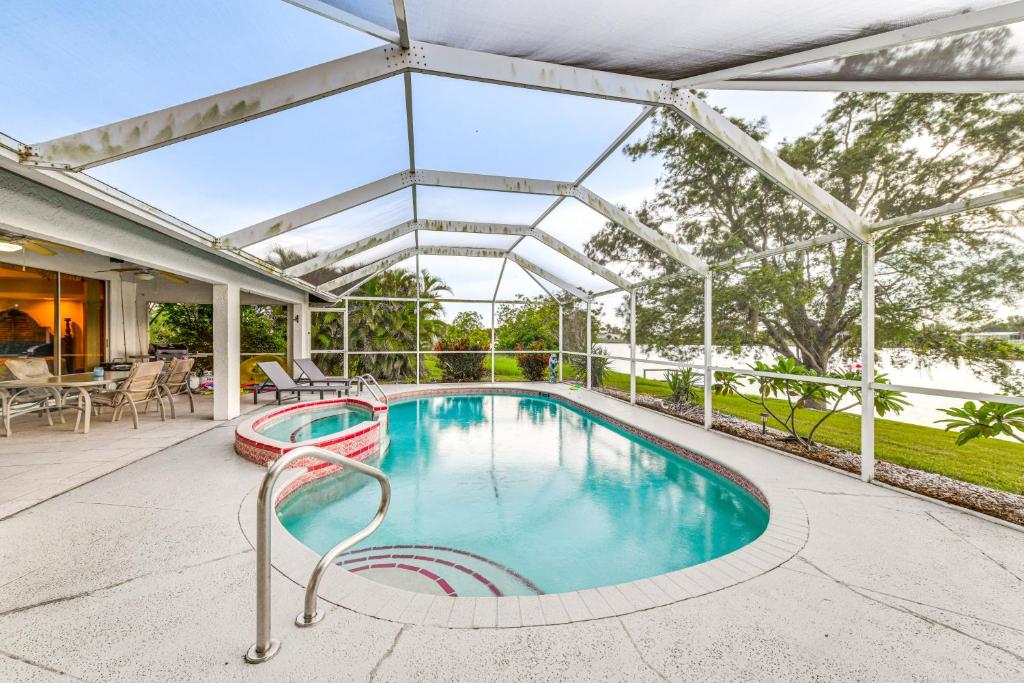 an indoor swimming pool with a glass roof at Private Dock Waterfront Port Charlotte Oasis! in Port Charlotte