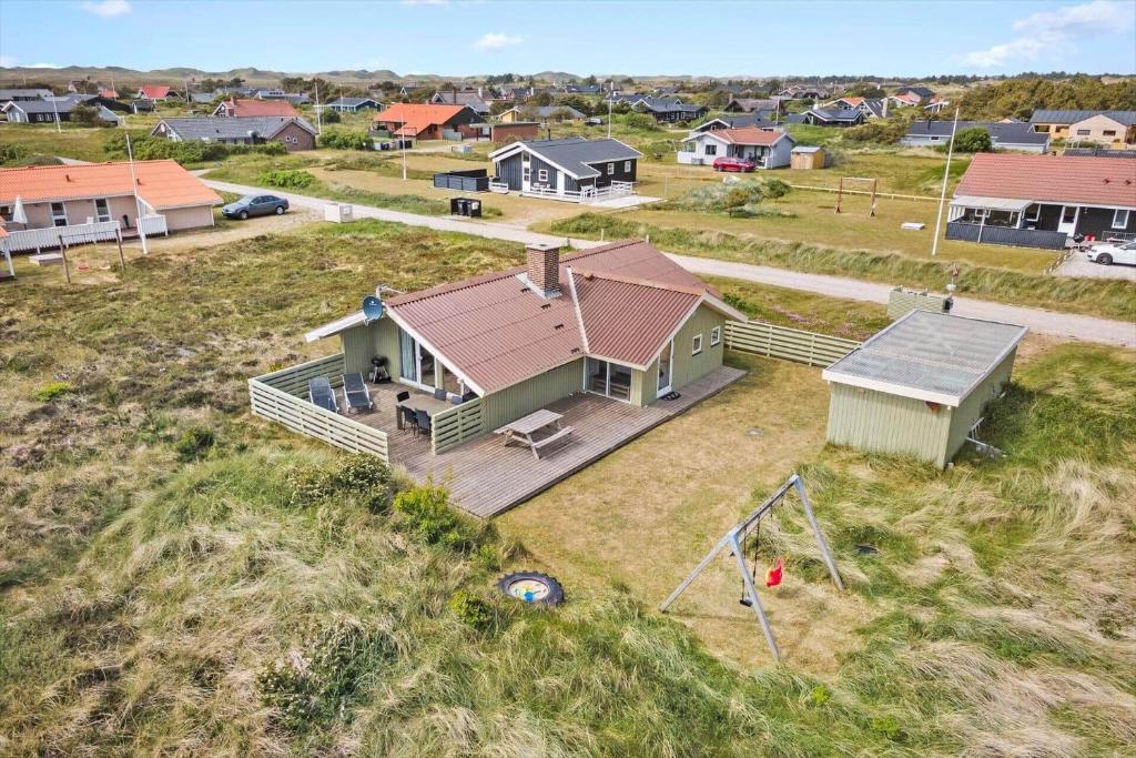 an aerial view of a house with a playground at 358-Hvide-Sande-Fyrmarken-25 in Hvide Sande