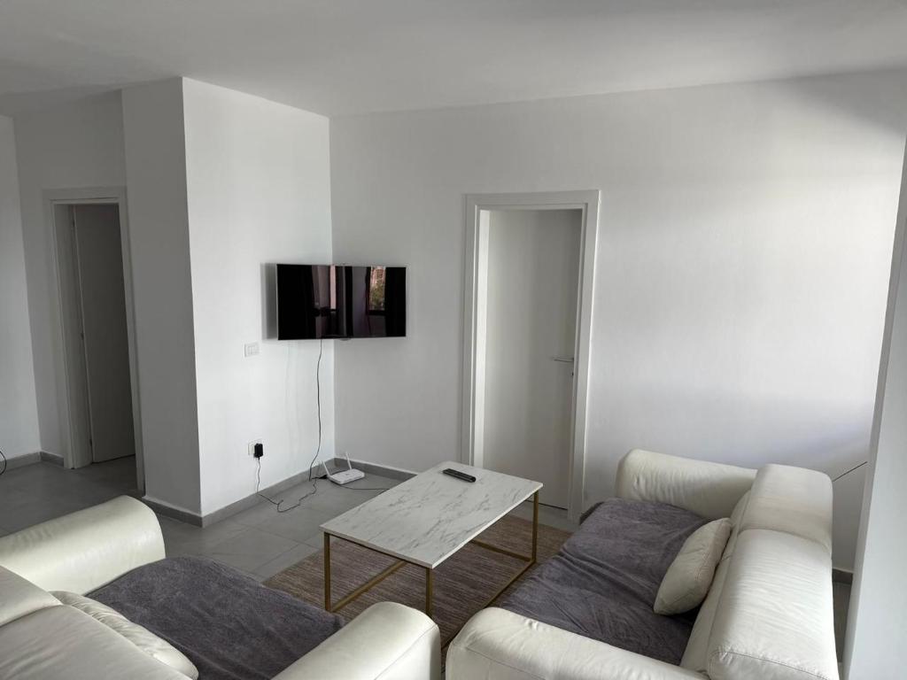 a living room with a couch and a table at Seaside 2-br flat with terrace in Golem
