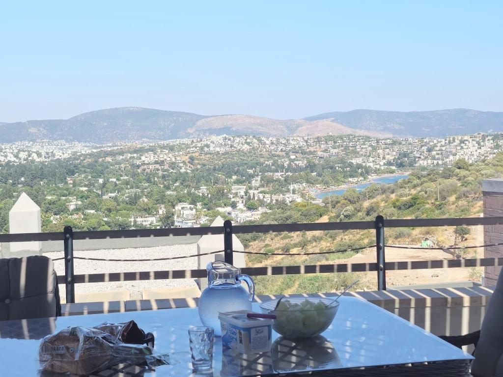 a blue table with a view of a city at Villa with Pool & View in Bitez in Bodrum City