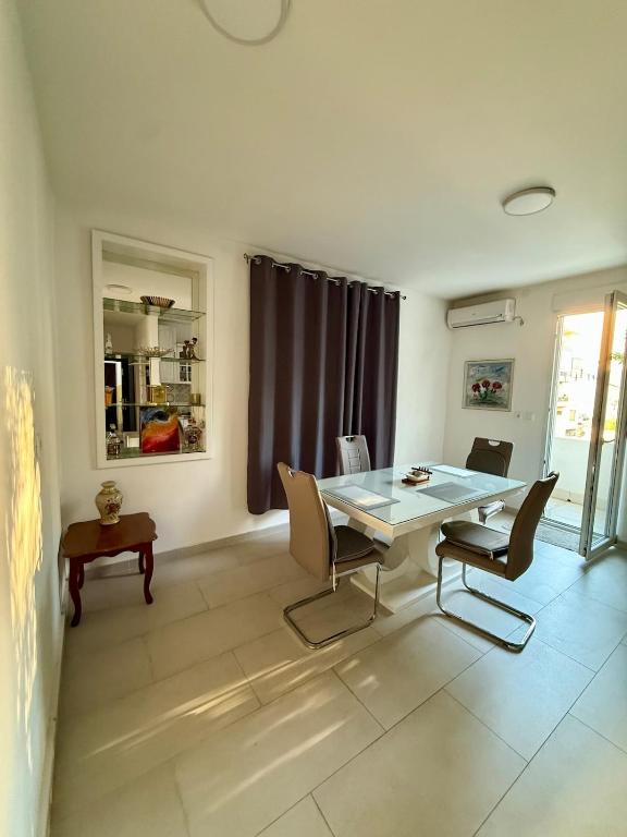a dining room with a table and some chairs at Center Oasis Retreat in Podgorica