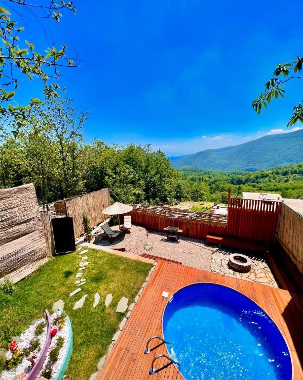 a backyard with a large swimming pool on a wooden deck at Opia Sapanca Bungalov in Sapanca
