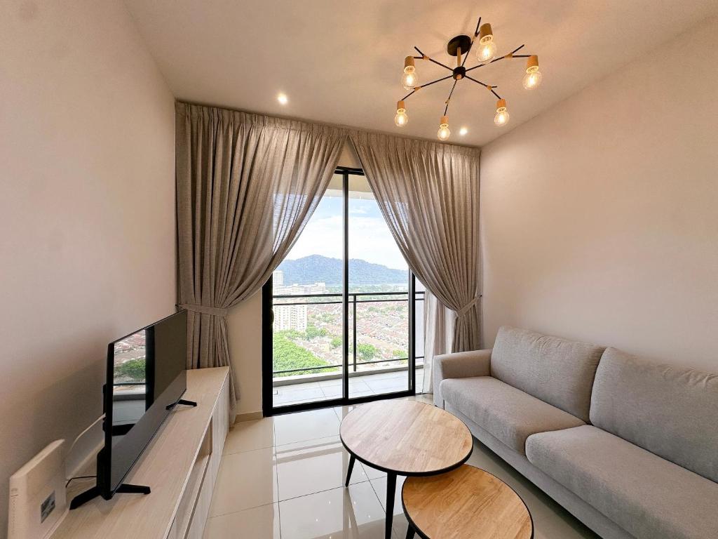 a living room with a couch and a table at Iconic Regency by Li in Bayan Lepas