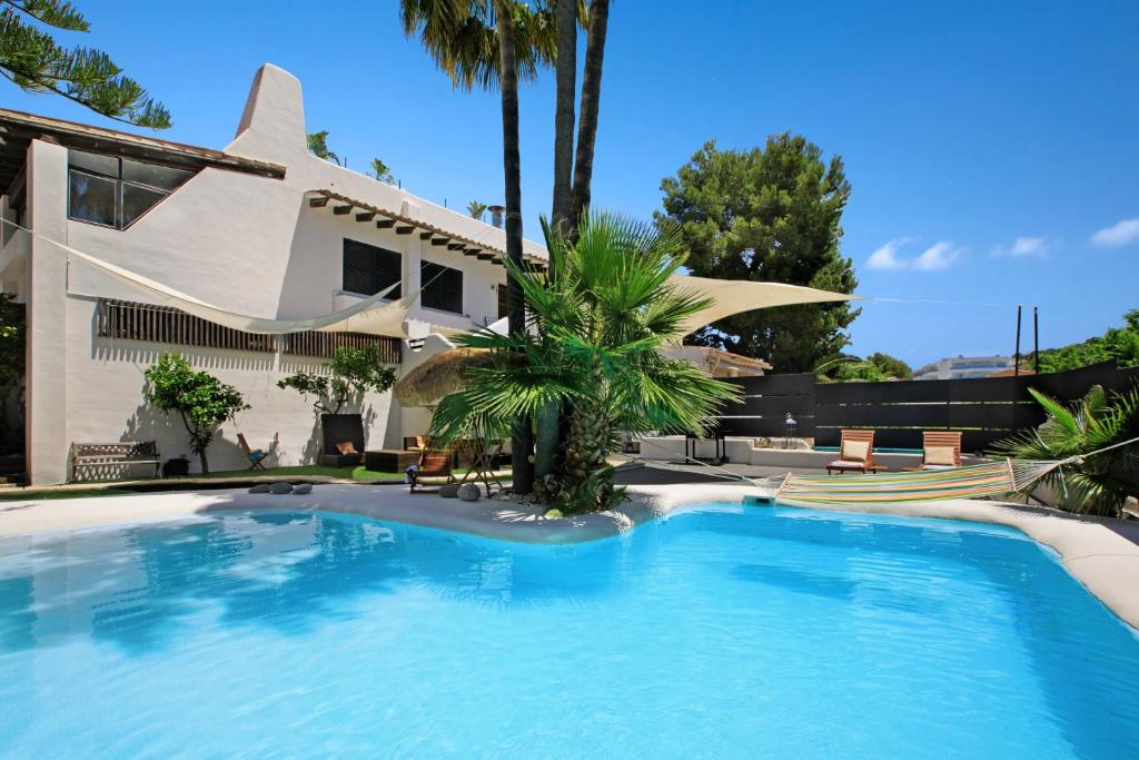 a swimming pool in front of a house at Apartamento Costa de la Calma in Costa de la Calma
