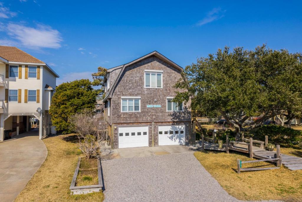 a large brick house with a white garage at Pescadora by Rather Be Properties in Frisco