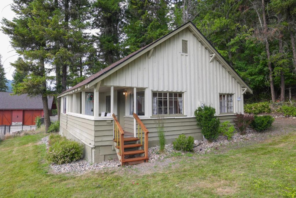 a small white house on a hill at Wilderness West Resort Cabin 1 in Colville