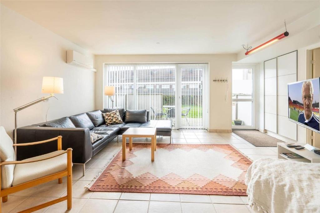 a living room with a couch and a tv at 770-Hvide-Sande-Norregade-4-B in Hvide Sande