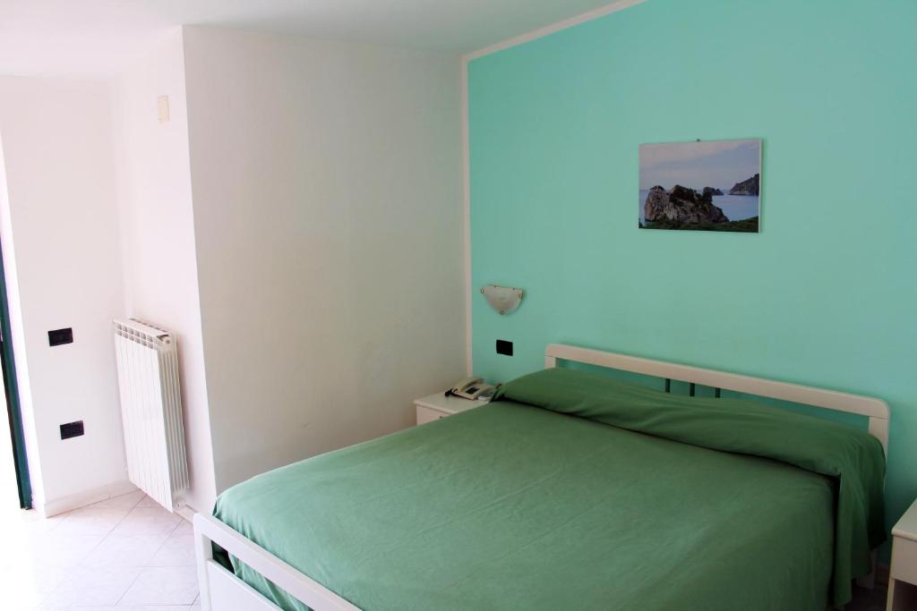 Postel nebo postele na pokoji v ubytování Hotel Ulisse