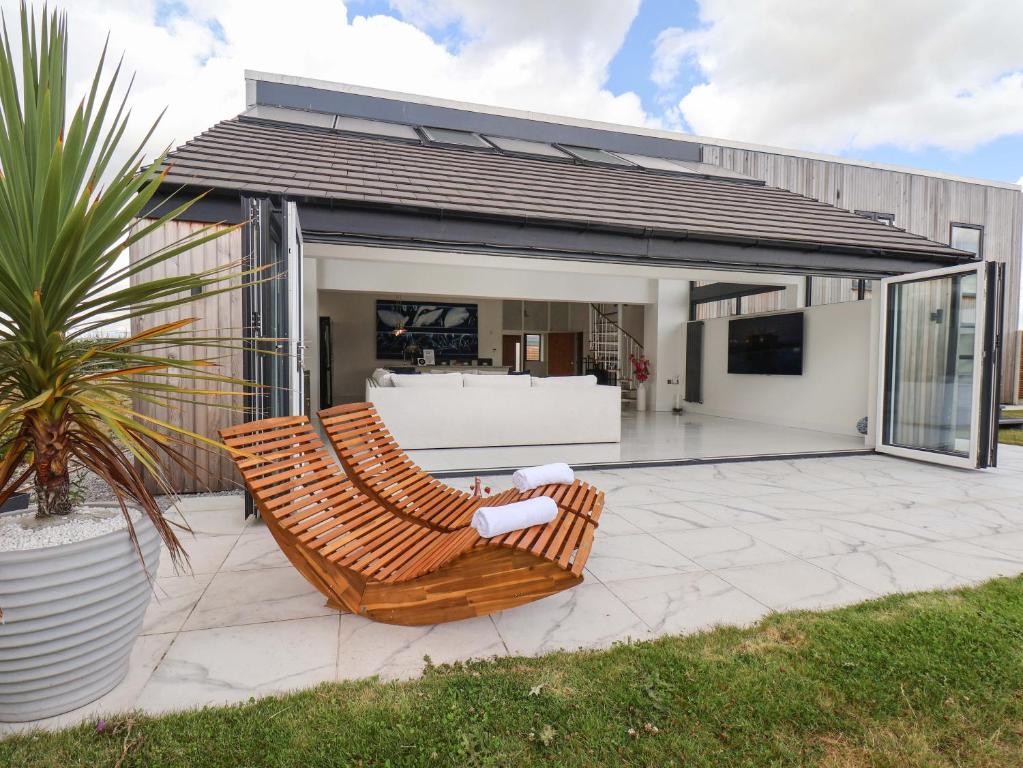 a pair of chairs on a patio in front of a house at Meadow View in Beverley