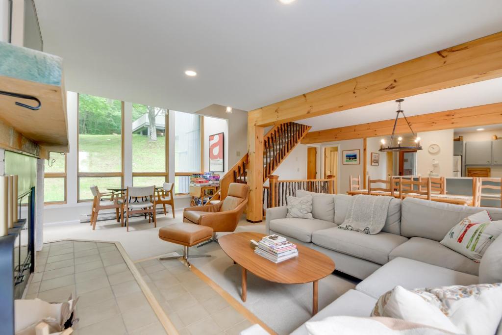 a living room with a couch and a table at Ski-InandSki-Out Sugarbush Retreat with Indoor Hot Tub in Warren